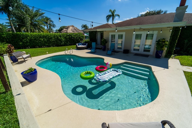 view of pool featuring french doors and a patio