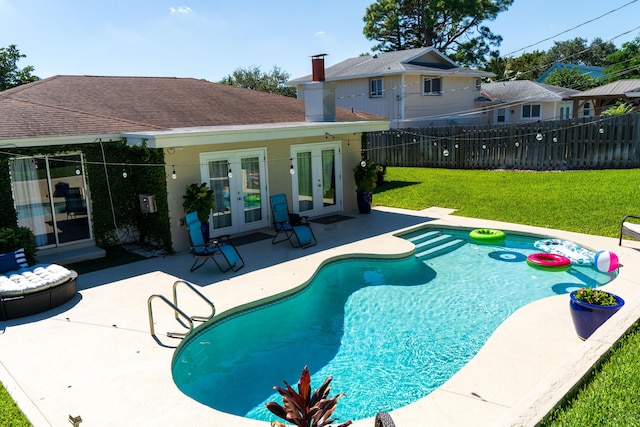 view of swimming pool with french doors and a patio area