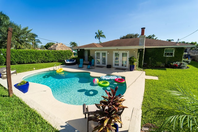 view of swimming pool featuring french doors and a patio
