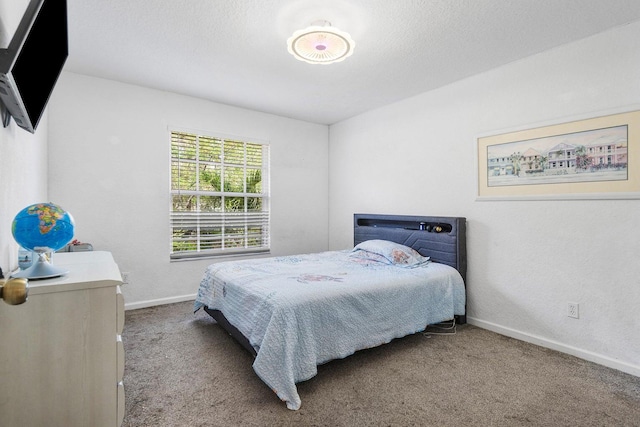 bedroom featuring carpet and baseboards