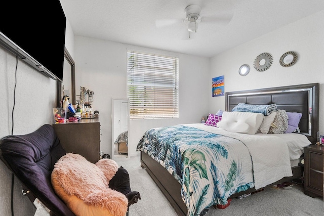 bedroom featuring light colored carpet and ceiling fan
