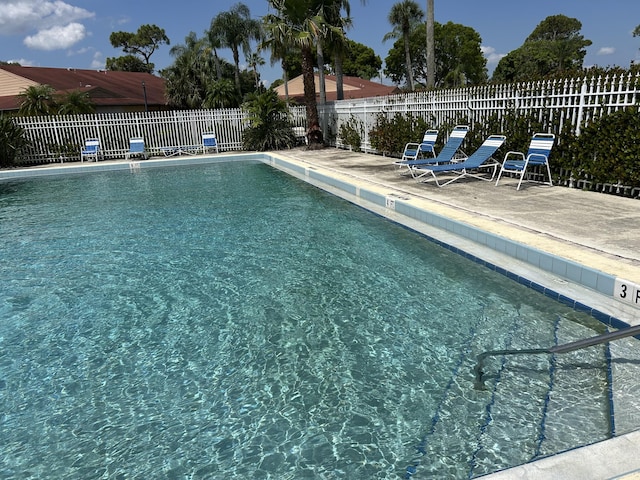 4393 Woodstock Dr Unit C, West Palm Beach, FL 33409 - community pool with a fenced backyard and a patio