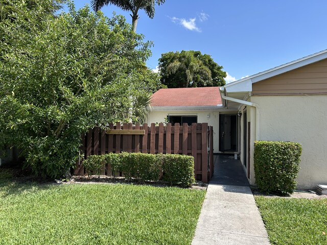 4393 Woodstock Dr Unit C, West Palm Beach, FL 33409 - entrance to property with stucco siding