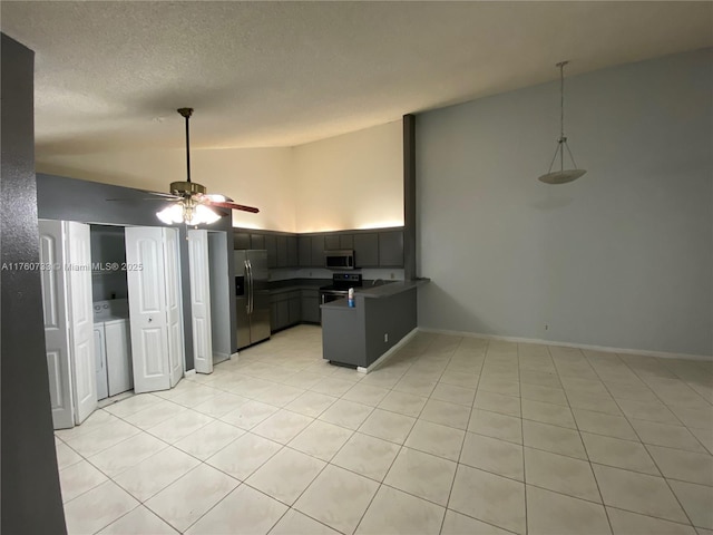 4393 Woodstock Dr Unit C, West Palm Beach, FL 33409 - kitchen with stainless steel appliances, a peninsula, lofted ceiling, ceiling fan, and dark countertops