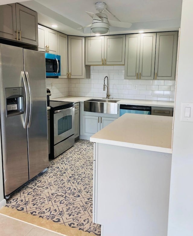 9370 SW 8th St Unit 323, Boca Raton, FL 33428 - kitchen featuring appliances with stainless steel finishes, a sink, tasteful backsplash, and light countertops