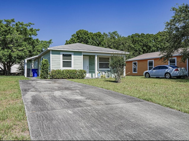 4257 36th Ct, Vero Beach, FL 32967 - view of front of property with a front yard and concrete driveway