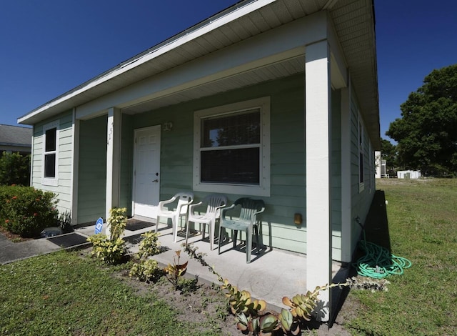 4257 36th Ct, Vero Beach, FL 32967 - rear view of property with covered porch and a lawn