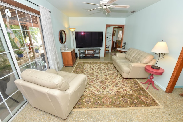 1116 NE Oceanview Cir, Jensen Beach, FL 34957 - living area with arched walkways, a ceiling fan, and baseboards
