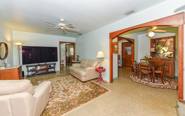 1116 NE Oceanview Cir, Jensen Beach, FL 34957 - living area featuring a ceiling fan, arched walkways, speckled floor, and baseboards