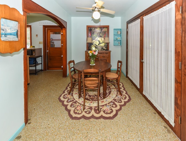 1116 NE Oceanview Cir, Jensen Beach, FL 34957 - dining area with arched walkways and a ceiling fan