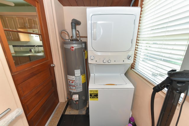 1116 NE Oceanview Cir, Jensen Beach, FL 34957 - laundry room featuring water heater and stacked washer and clothes dryer