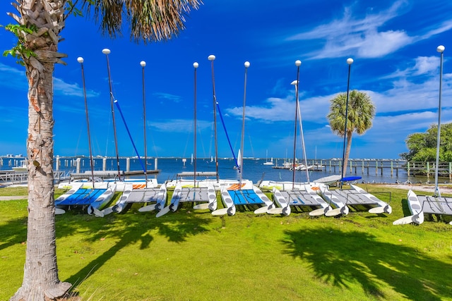 1116 NE Oceanview Cir, Jensen Beach, FL 34957 - view of property's community with a boat dock, a water view, and a yard