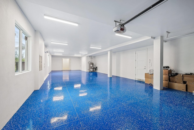 garage featuring a garage door opener, water heater, and an indoor pool
