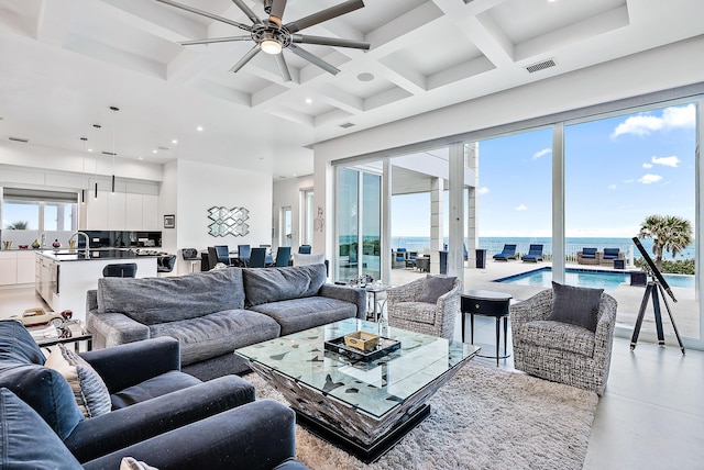 living area featuring a ceiling fan, coffered ceiling, beamed ceiling, a towering ceiling, and recessed lighting