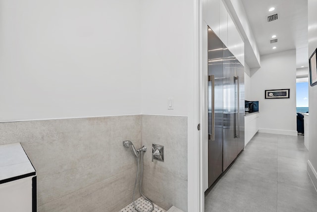 bathroom with recessed lighting and concrete floors