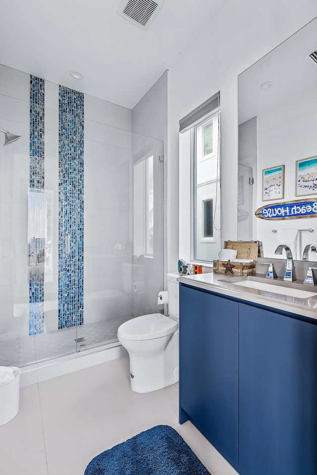 full bath featuring a stall shower, toilet, vanity, and tile patterned floors