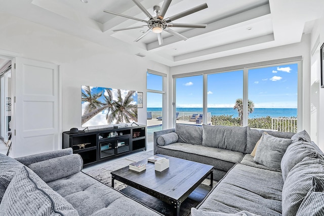living room featuring ceiling fan and beamed ceiling