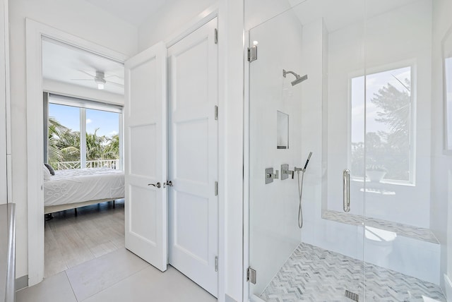 full bathroom featuring a stall shower, ensuite bathroom, tile patterned flooring, and ceiling fan
