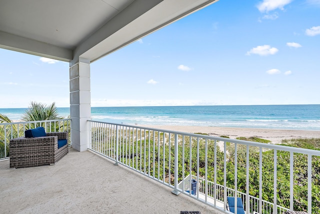 balcony featuring view of water and beach