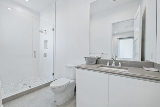 bathroom featuring toilet, a shower stall, vanity, and tile patterned flooring