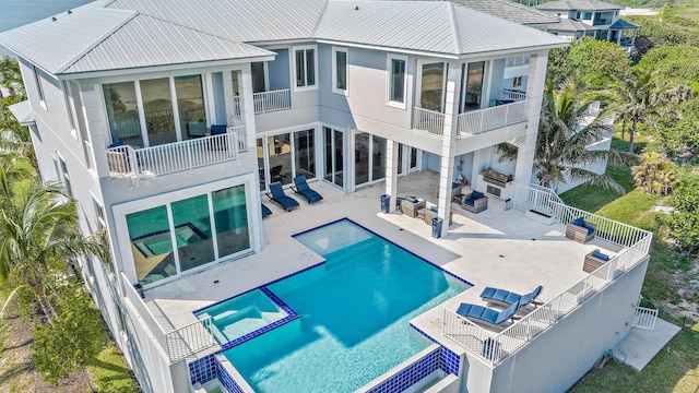 back of house featuring a balcony, an outdoor hangout area, and a patio
