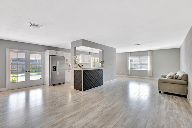 1181 Larch Way, Wellington, FL 33414 - living room featuring baseboards, light wood-style floors, and french doors