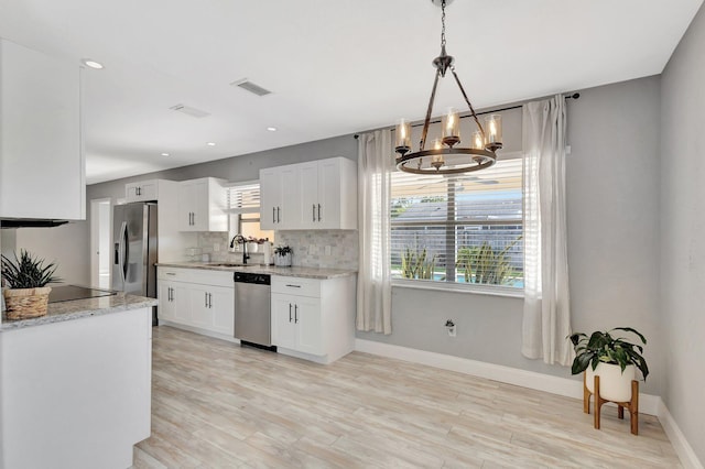 1181 Larch Way, Wellington, FL 33414 - kitchen with stainless steel appliances, a sink, plenty of natural light, a chandelier, and recessed lighting