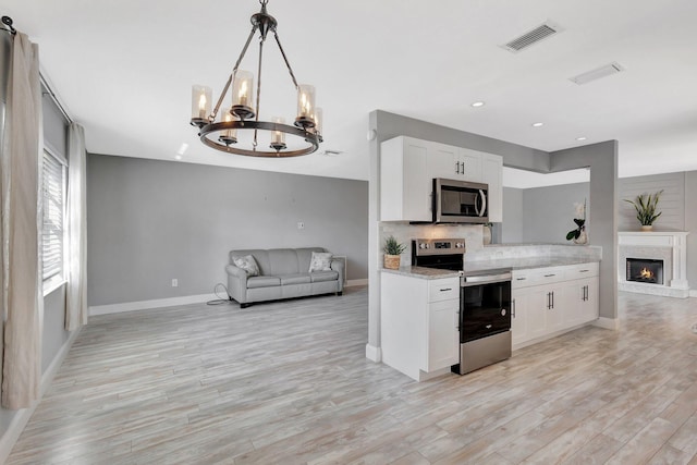 1181 Larch Way, Wellington, FL 33414 - kitchen with appliances with stainless steel finishes, open floor plan, a chandelier, baseboards, and recessed lighting
