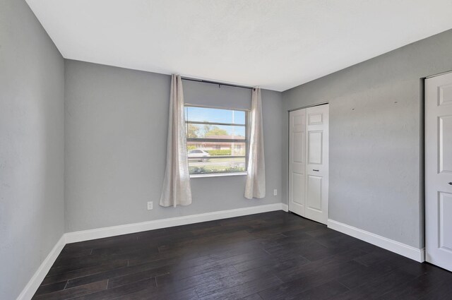 1181 Larch Way, Wellington, FL 33414 - spare room featuring baseboards and dark wood-style floors