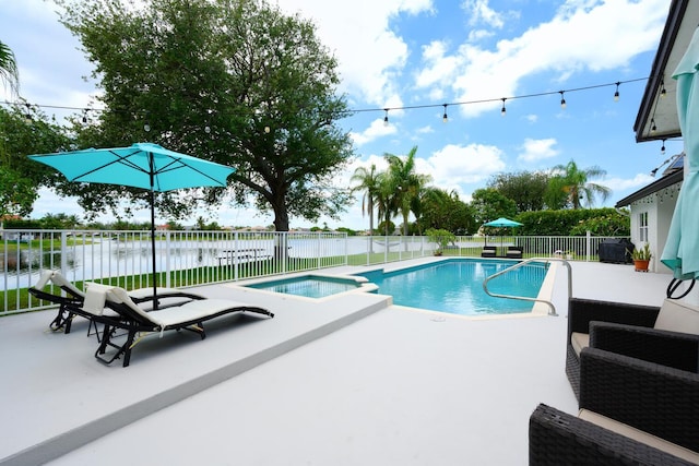 7340 Anadale Cir, Lake Worth, FL 33467 - view of swimming pool with a patio, a fenced backyard, a water view, and an in-ground hot tub