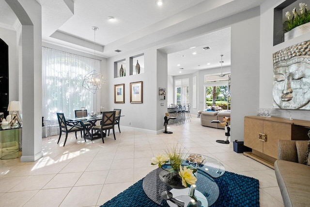 living room featuring a chandelier, light tile patterned floors, baseboards, recessed lighting, and a towering ceiling