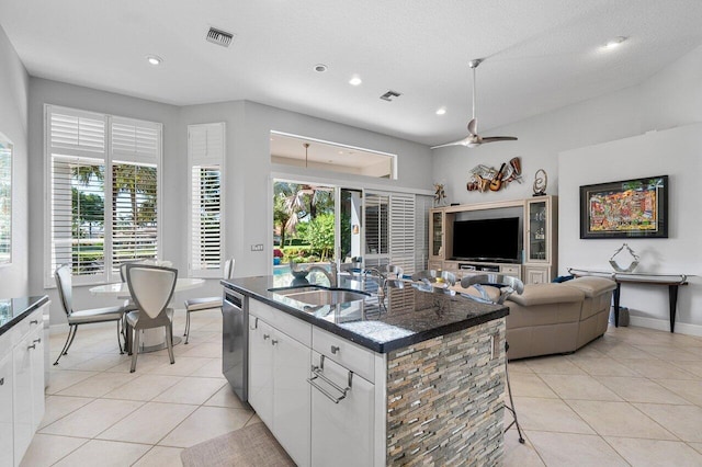kitchen with light tile patterned floors, stainless steel dishwasher, white cabinets, ceiling fan, and recessed lighting