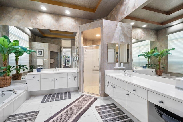 bathroom featuring a shower stall, tile patterned floors, two vanities, and a bath