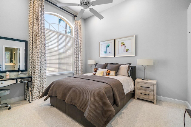 bedroom featuring light colored carpet, multiple windows, and baseboards