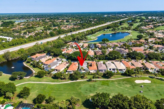 aerial view of property's location with a large body of water, nearby suburban area, and a local golf course