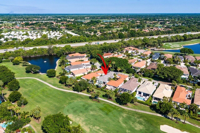 aerial overview of property's location featuring a nearby body of water, a local golf course, and nearby suburban area