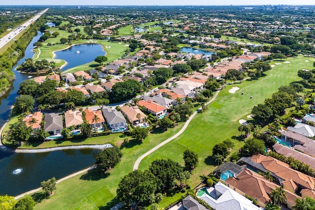 aerial overview of property's location featuring nearby suburban area, a golf course, and a nearby body of water