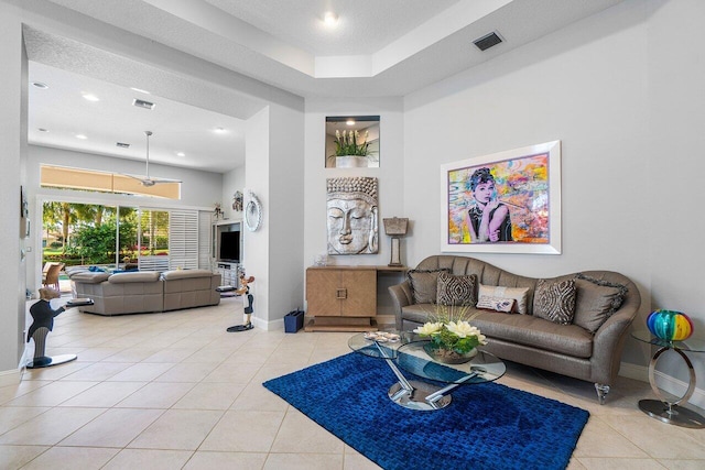 living area with baseboards, light tile patterned floors, and recessed lighting