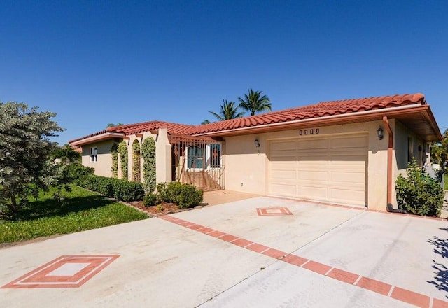 1117 SE Mendoza Ave, Port Saint Lucie, FL 34952 - mediterranean / spanish-style home featuring stucco siding, an attached garage, concrete driveway, and a tiled roof