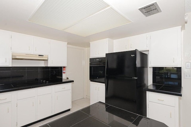 1117 SE Mendoza Ave, Port Saint Lucie, FL 34952 - kitchen featuring black appliances, under cabinet range hood, dark countertops, and backsplash