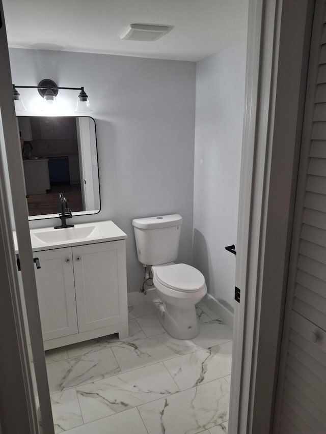 6515 Chasewood Dr Unit D, Jupiter, FL 33458 - bathroom featuring vanity, toilet, and marble look tile flooring