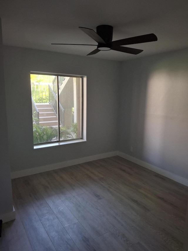6515 Chasewood Dr Unit D, Jupiter, FL 33458 - empty room with wood finished floors, a ceiling fan, and baseboards