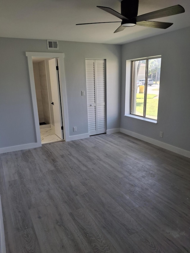 6515 Chasewood Dr Unit D, Jupiter, FL 33458 - unfurnished bedroom with wood finished floors, baseboards, a ceiling fan, and a closet