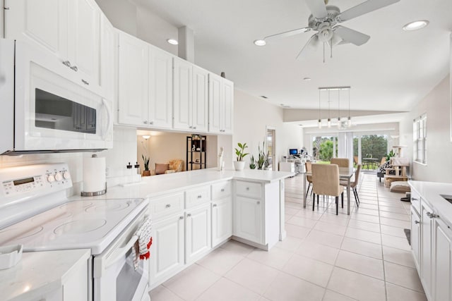 10853 SW Elsinore Dr, Port Saint Lucie, FL 34987 - kitchen with white appliances, light countertops, white cabinets, ceiling fan, and recessed lighting