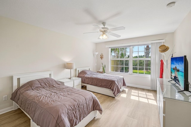 10853 SW Elsinore Dr, Port Saint Lucie, FL 34987 - bedroom with light wood-style floors, baseboards, and a ceiling fan