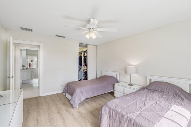 10853 SW Elsinore Dr, Port Saint Lucie, FL 34987 - bedroom featuring light wood-type flooring, a closet, a ceiling fan, and baseboards