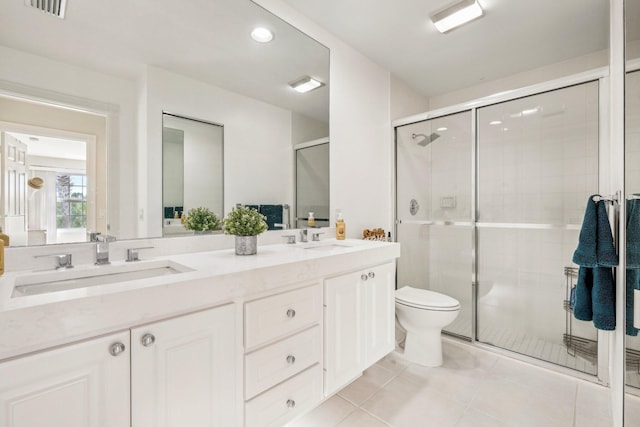 10853 SW Elsinore Dr, Port Saint Lucie, FL 34987 - bathroom with a stall shower, tile patterned floors, double vanity, toilet, and recessed lighting