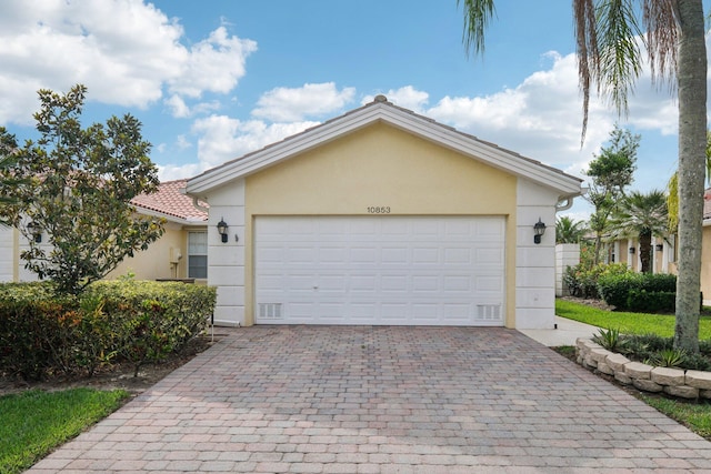 10853 SW Elsinore Dr, Port Saint Lucie, FL 34987 - view of front facade with stucco siding and decorative driveway