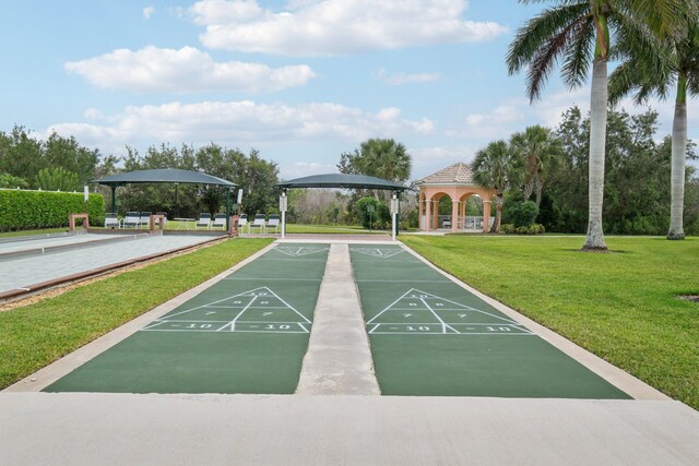 10853 SW Elsinore Dr, Port Saint Lucie, FL 34987 - view of home's community with a gazebo, a yard, and shuffleboard