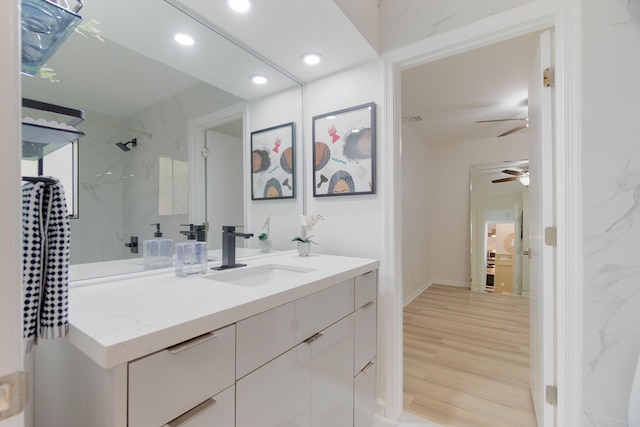 11892 Sturbridge Ln, Wellington, FL 33414 - full bath with vanity, a ceiling fan, a marble finish shower, recessed lighting, and wood finished floors